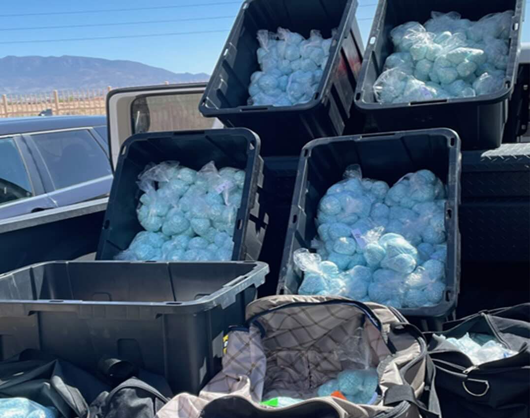 Agents posing with evidence from the largest fentanyl bust in DEA history May 2025